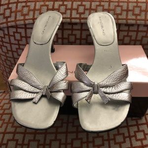 A pair of silver slip on.. beautiful sandal, worned 1 time .. box included